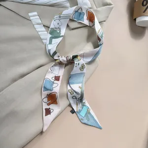 Detailed close-up of a double-sided twilly silk scarf with colorful fashion illustrations