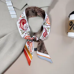 Autumn paisley and leopard print silk-feel ribbon scarf tied in a bow on a blazer