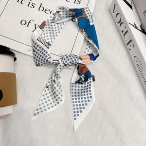 Elegant narrow silk scarf with blue horse patterns and geometric prints on white background
