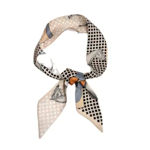 Elegant narrow silk scarf featuring vintage horse patterns and polka dots on peach fabric