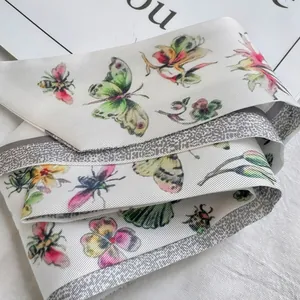 Macro detail of textured silk scarf featuring floral and insect prints with ribbed fabric