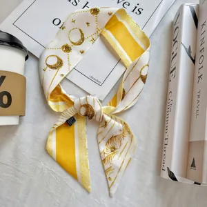 Detail of floral silk scarf tied in a bow with visible wash label and moon print