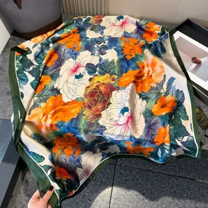 Luxurious satin silk scarf featuring vibrant floral prints and elegant dark green edges
