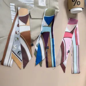 Close-up of three vintage-style skinny silk scarves in brown, blue, and pink patterns