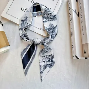 Flat lay detail of French Toile de Jouy silk twilly scarf with black and white patterns