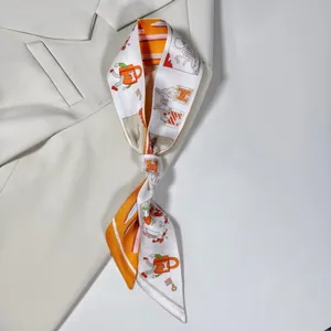 Close-up of printed silk twilly scarf with retro pattern tied on a cream suit collar