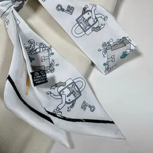 Detail shot of vintage cartoon print silky twilly scarf featuring 100% polyester wash label