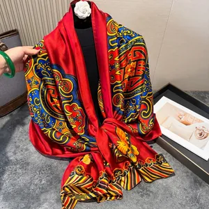 Close-up of red silk scarf with traditional Chinese cloud patterns and glossy finish