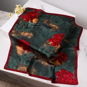 Classic Chinese silk scarf featuring red peonies on deep green with gold patterns