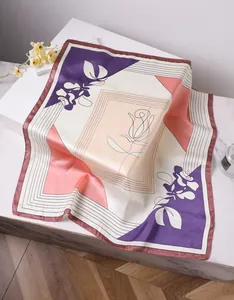 Artistic floral silk scarf with purple and pink patterns elegantly folded on a white stand
