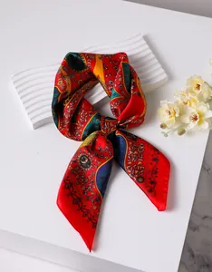 Close-up of vintage paisley pattern silk square scarf with floral prints on a display