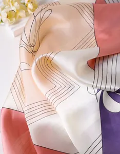 Close-up of elegant floral silk scarf with abstract patterns and smooth satin texture