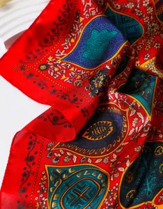 Detail of red vintage paisley silk scarf texture with bohemian floral patterns and silk sheen