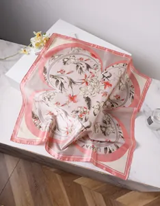 Close-up of floral print silk scarf with narcissus patterns and elegant pink borders