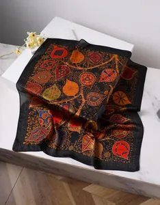 Detailed view of bohemian floral paisley print on silk-like square scarf with satin finish