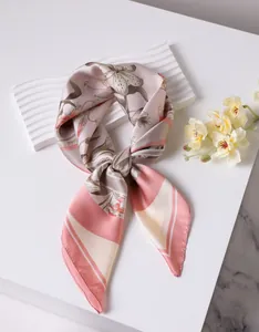 Detailed view of elegant floral silk scarf with lily print and soft satin texture