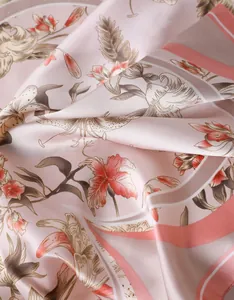 Macro shot of faux silk scarf showing delicate lily print and smooth satin texture