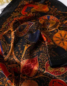 Detailed texture of paisley pattern silk scarf with vibrant floral and ethnic prints