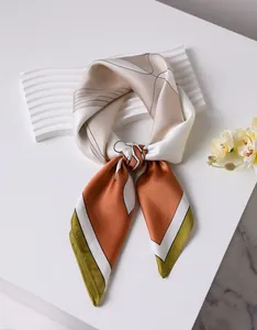Close-up of elegant silk scarf with abstract geometric patterns in earthy tones