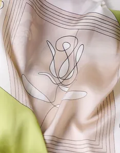 Detail of silk scarf showing elegant floral patterns and smooth satin fabric texture