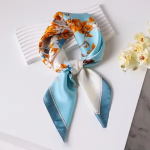 70cm light blue silk square scarf with orange floral print tied on a wave display