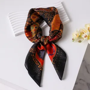Vintage paisley silk square scarf with red and gold patterns on a black background