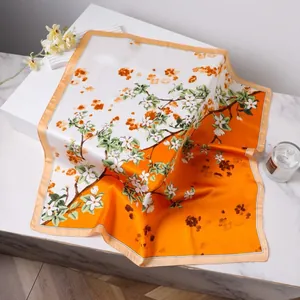 70cm elegant orange and white silk scarf with floral print on marble surface
