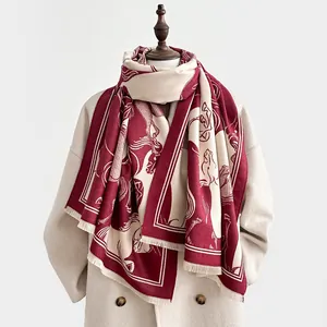 Detail of wool blend scarf with horse print, wine red color and soft fringe texture