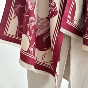Close-up of jacquard wool scarf with retro horse patterns and fringed edges in burgundy