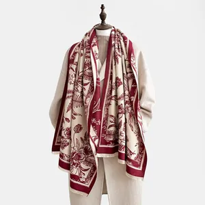 Detail of vintage floral cashmere scarf with burgundy patterns and fringe edges