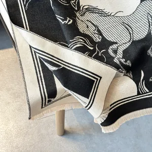 Detail of premium wool scarf featuring horse knit pattern and fine fringe edge details