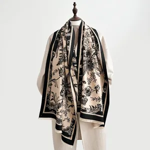 Detail of vintage floral cashmere scarf featuring elegant black toile print and fringe edges