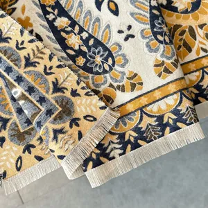 Close-up of paisley jacquard cashmere-feel scarf with intricate fringe details