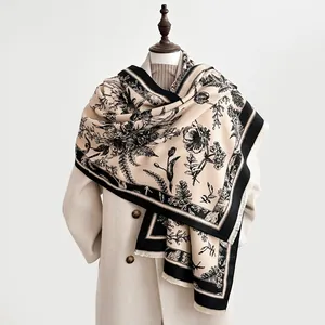 Close-up of floral cashmere feel shawl with intricate vintage plant patterns in beige and black