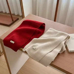 Classic knitted wool scarf in red and cream white colors for autumn and winter season