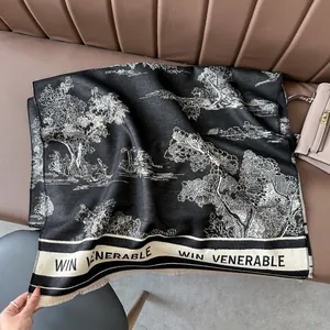 Close-up of black and white landscape print cashmere scarf with tassel edges