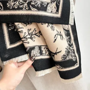 Close-up of vintage floral jacquard pattern and tassel edges on thick cashmere-like shawl