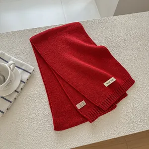 Detail of wool scarf with composition label showing 70% acrylic and 30% wool