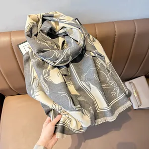 Detail of gray and cream wool shawl with abstract art lines and tassel fringe finish