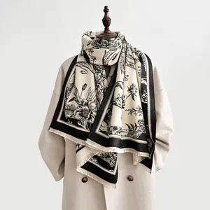 Detailed view of black and white floral pattern shawl with soft tassel edges