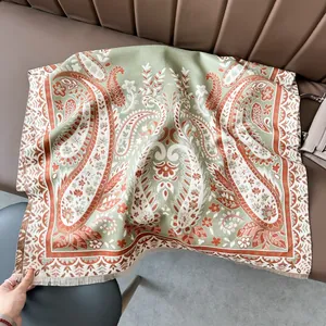Detail of vintage paisley cashmere-feel shawl with intricate floral patterns and tassels