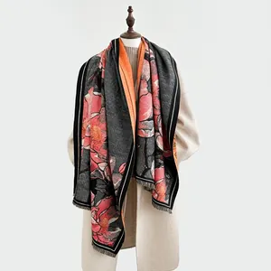 Dettaglio di un elegante scialle in cashmere con stampa di peonia e bordi con frange