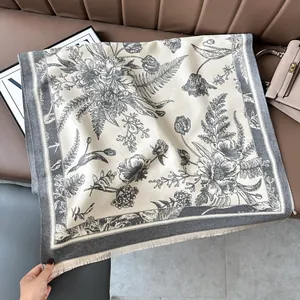 Close-up of vintage floral cashmere scarf featuring detailed fringe and elegant patterns