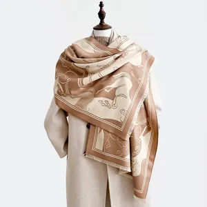 Detailed macro view of the thick wool scarf fabric texture with horse pattern and fringes
