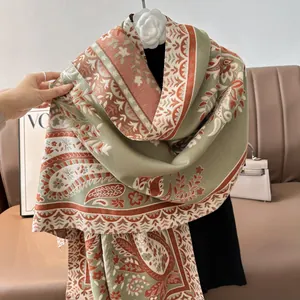 Detail of vintage paisley pattern on thick cashmere-like scarf with knitted texture