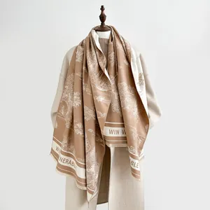 Detailed texture of thick cashmere scarf with landscape pattern and fringed edges