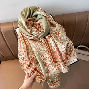 Detail of vintage paisley pattern and tassel trim on thick imitation cashmere scarf