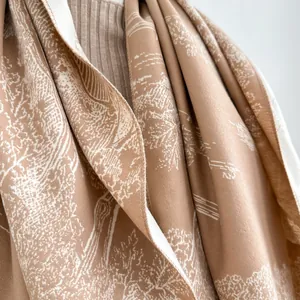 Detail view of landscape print on premium beige cashmere scarf with elegant draping texture