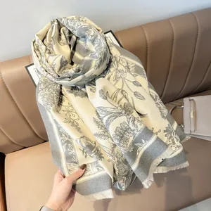 Close-up of floral cashmere feel shawl with vintage pattern and fringe detail