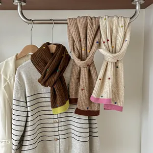Chic knit wool scarf with colorful polka dots and ribbed texture for winter warmth